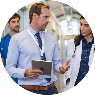 Businessman holding a tablet showing a a doctor statistics with nurse in the background